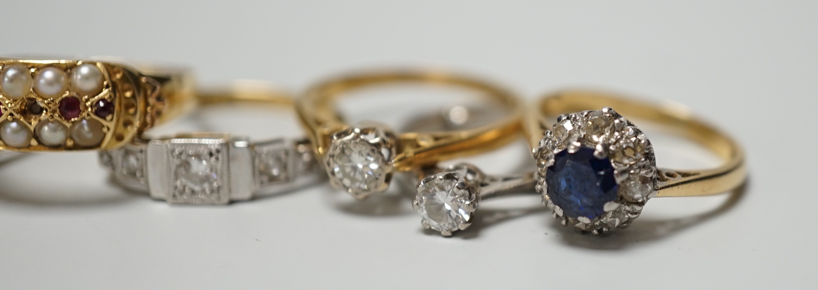 Five assorted 18ct and gem set rings, including 1920's millegrain diamond set, two solitaire diamond rings, sapphire and diamond cluster and amethyst and diamond half hoop (stone replaced and repair) and one other yellow